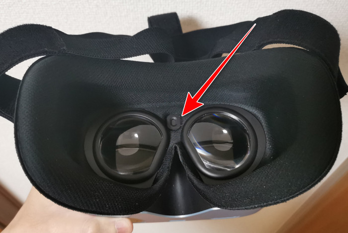 箭頭指向兩個鏡片之間的臉部感應器